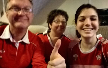 Theresa with student in Welsh rugby shirts